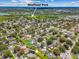 Wide aerial view of a home near Sheffield Park, surrounded by a lush, tree-lined neighborhood at 1910 Montego Ct, Oldsmar, FL 34677