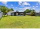 Expansive backyard with a screened pool enclosure, providing a serene outdoor living space at 1910 Montego Ct, Oldsmar, FL 34677