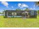 Spacious backyard featuring a pool, patio, and screened enclosure, perfect for outdoor living and entertaining at 1910 Montego Ct, Oldsmar, FL 34677