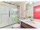 Bathroom featuring a glass shower door, white subway tile, and a dark vanity with white countertops at 1910 Montego Ct, Oldsmar, FL 34677
