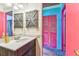 Bathroom showcasing colorful decor, a white vanity, and unique wooden shutter-style wall decorations at 1910 Montego Ct, Oldsmar, FL 34677