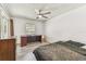 Bedroom featuring gray wood-look flooring, a ceiling fan, a window, and a desk at 1910 Montego Ct, Oldsmar, FL 34677