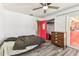 Bedroom with gray floors, a ceiling fan, red accent door, and sliding glass door at 1910 Montego Ct, Oldsmar, FL 34677