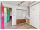Bedroom with closet and storage near the Murphy bed with wood-look flooring and a colorful hallway at 1910 Montego Ct, Oldsmar, FL 34677