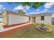Well-maintained home featuring desert landscaping, solar panels, and a charming brick facade at 1910 Montego Ct, Oldsmar, FL 34677