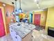 Island with white cabinets and stone countertops, with a view of the living room at 1910 Montego Ct, Oldsmar, FL 34677