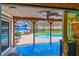 View from inside looking out at a covered patio with a pool and seating area at 1910 Montego Ct, Oldsmar, FL 34677