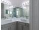 Bathroom with double sinks, cabinets, and large mirrors at 19232 Stone Hedge Dr, Tampa, FL 33647