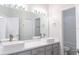 Modern bathroom with double sinks, a large mirror, and a shower/tub combo at 19232 Stone Hedge Dr, Tampa, FL 33647
