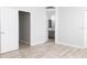 Bedroom with light gray wood-look floors and a door to the ensuite bath at 19232 Stone Hedge Dr, Tampa, FL 33647