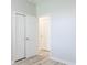 Bright room with wood-look floors and closet with double doors at 19232 Stone Hedge Dr, Tampa, FL 33647
