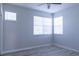 Bright bedroom featuring durable flooring, a ceiling fan, and multiple windows for ample natural light at 19232 Stone Hedge Dr, Tampa, FL 33647