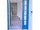 Bright foyer boasts a blue door, wood-look floors, and staircase to the upper level at 19232 Stone Hedge Dr, Tampa, FL 33647