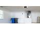 Clean garage interior featuring white walls, tile flooring, and essential utilities at 19232 Stone Hedge Dr, Tampa, FL 33647