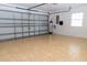Spacious garage with tile flooring and a large, paneled garage door at 19232 Stone Hedge Dr, Tampa, FL 33647