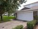 One car garage door, stone accents, and a well-maintained lawn showcase the building's exterior at 19232 Stone Hedge Dr, Tampa, FL 33647