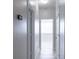 Bright hallway with sleek flooring, white trim, and multiple doorways creating an open, airy feel at 19232 Stone Hedge Dr, Tampa, FL 33647
