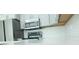 Modern kitchen appliances with white cabinets and a mosaic tile backsplash at 19232 Stone Hedge Dr, Tampa, FL 33647