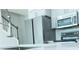 Modern kitchen features stainless steel appliances, a backsplash, and light gray cabinets at 19232 Stone Hedge Dr, Tampa, FL 33647