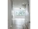 Bright and airy living room with a large window and wood-look flooring at 19232 Stone Hedge Dr, Tampa, FL 33647