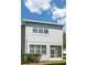 Rear exterior showcasing a screened-in porch, neat landscaping, and windows that offer natural light to the home at 19232 Stone Hedge Dr, Tampa, FL 33647