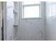 Bright shower stall with white marble-style tiles and shelving at 19232 Stone Hedge Dr, Tampa, FL 33647