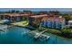 Waterfront condo complex featuring boat lifts and community pool on a sunny day with water views at 19717 Gulf Blvd # V5, Indian Shores, FL 33785