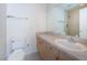 Bathroom with a large mirror, vanity, sink, and shower featuring a tiled wall at 19717 Gulf Blvd # V5, Indian Shores, FL 33785