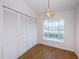 Sunlit bedroom featuring a closet, a window with a cozy window seat, and classic wooden flooring for comfort at 19717 Gulf Blvd # V5, Indian Shores, FL 33785