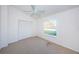 Bright bedroom features a ceiling fan, closet and window providing natural light at 19717 Gulf Blvd # V5, Indian Shores, FL 33785
