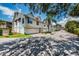 A street view of the condo complex exteriors, each with a private garage and lush tropical landscaping at 19717 Gulf Blvd # V5, Indian Shores, FL 33785