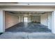 Spacious two car garage with concrete floors and white walls at 19717 Gulf Blvd # V5, Indian Shores, FL 33785