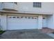 Garage exterior, complete with a garage door and pedestrian entrance at 19717 Gulf Blvd # V5, Indian Shores, FL 33785