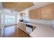 Classic kitchen featuring light wood cabinets, white countertops, and modern appliances with view into adjacent breakfast nook at 19717 Gulf Blvd # V5, Indian Shores, FL 33785