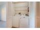Washer and dryer nestled within closet with shelving at 19717 Gulf Blvd # V5, Indian Shores, FL 33785