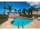 Community pool surrounded by palm trees and lounge chairs at 19717 Gulf Blvd # V5, Indian Shores, FL 33785