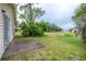 A view of the home's backyard, showing lush greenery and the home's exterior at 208 Oakwood Blvd, Oldsmar, FL 34677