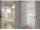 This bathroom boasts a shower-tub combo, vanity, and open doorway to a carpeted bedroom at 208 Oakwood Blvd, Oldsmar, FL 34677
