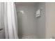 This bathroom features a gray tiled shower with a shower curtain and grab bar at 208 Oakwood Blvd, Oldsmar, FL 34677