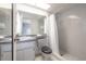 This bathroom features a granite-look vanity and shower with modern fixtures at 208 Oakwood Blvd, Oldsmar, FL 34677