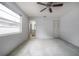 A neutral-toned bedroom with an ensuite bathroom, ceiling fan, and closet at 208 Oakwood Blvd, Oldsmar, FL 34677