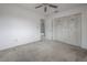 Bedroom featuring neutral carpeting, a ceiling fan, and a closet with doors adorned with stickers, adding a personal touch at 208 Oakwood Blvd, Oldsmar, FL 34677