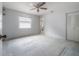 A large bedroom with neutral carpet, ceiling fan, and closet at 208 Oakwood Blvd, Oldsmar, FL 34677