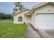Inviting home featuring a cozy front porch and an attached one-car garage at 208 Oakwood Blvd, Oldsmar, FL 34677
