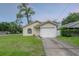 Charming single-Gathering home with a well-maintained lawn and an attached one-car garage at 208 Oakwood Blvd, Oldsmar, FL 34677