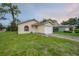 Charming yellow home with well-maintained front yard and driveway at 208 Oakwood Blvd, Oldsmar, FL 34677