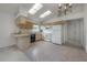 Kitchen with white appliances and light wood cabinets under vaulted ceilings with skylights at 208 Oakwood Blvd, Oldsmar, FL 34677