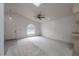 Bright living room with neutral carpeting, a ceiling fan, and a large arched window providing plenty of natural light at 208 Oakwood Blvd, Oldsmar, FL 34677