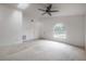 Spacious living area featuring vaulted ceilings, a ceiling fan, and a large arched window, providing ample natural light at 208 Oakwood Blvd, Oldsmar, FL 34677