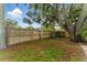 Secluded backyard space featuring mature trees, fencing for privacy, and a charming area to relax and enjoy the outdoors at 2272 Adam Ct, Palm Harbor, FL 34683